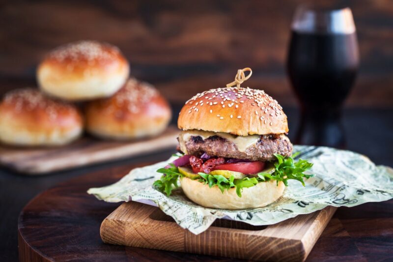 Fresh  homemade burger on wooden background, closeup